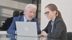Teammates Discussing Project on Laptop at Work