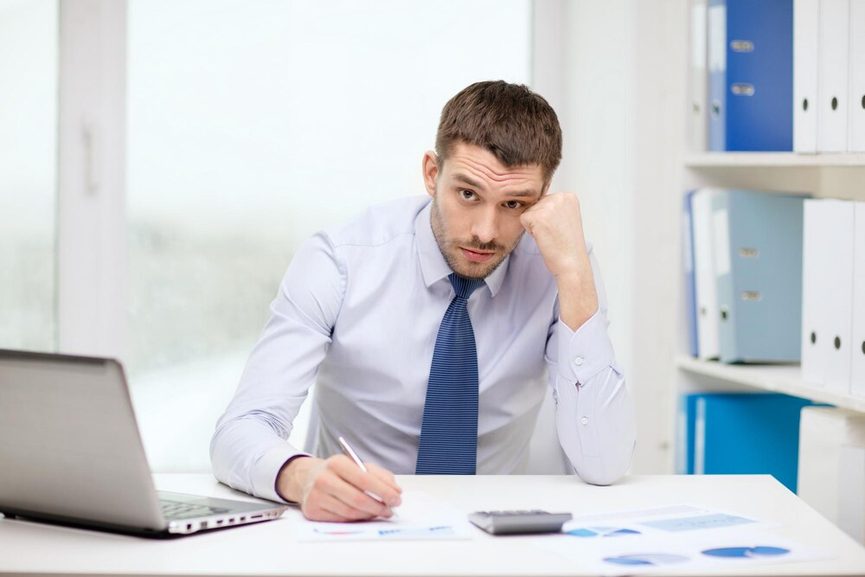 Pile de factures sur un bureau professionnel avec ordinateur