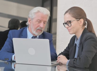 Teammates Discussing Project on Laptop at Work